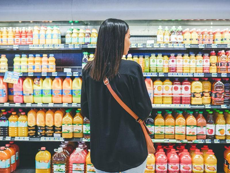 Woman browses beverage aisle Woman browses beverage aisle