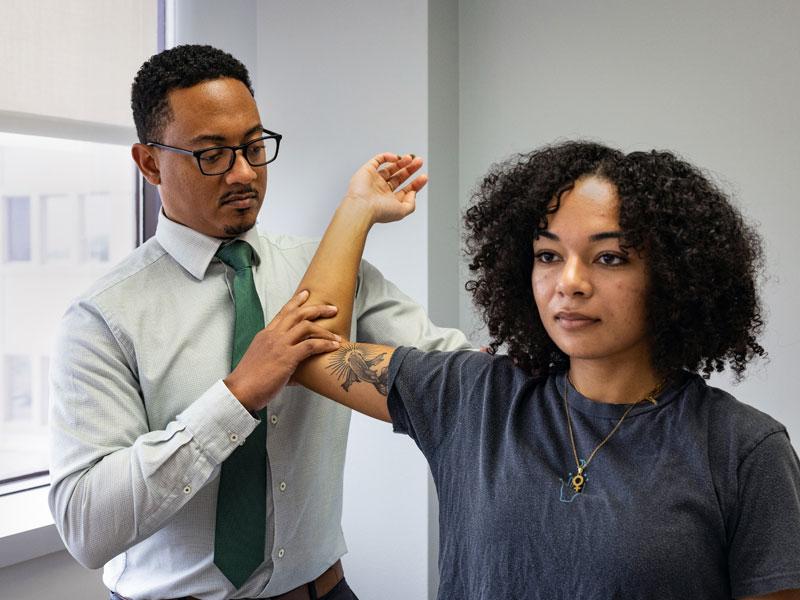 Doctor examines patient's arm Doctor examines patient's arm