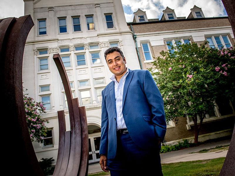 Michael Naguib poses for photo on campus