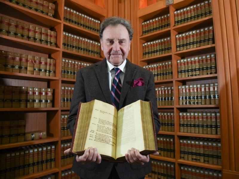 Tulane Law Professor Vernon Palmer holding book