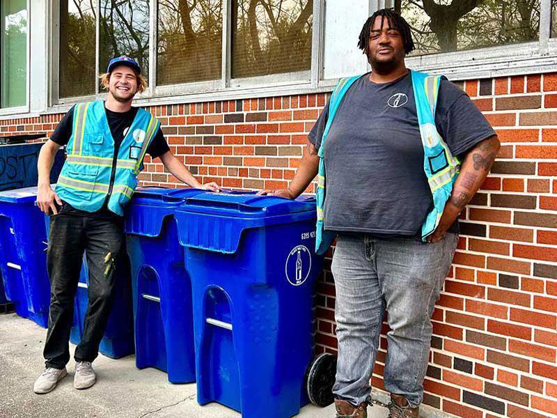 Max Steitz (left), Glass Half Full chief operations and financial officer, and Corey Cummings (right), Glass Half Full processing and logistics associate, set up the new Sharp Residence Hall glass collection hub. (Photo by Jordan Stewart)