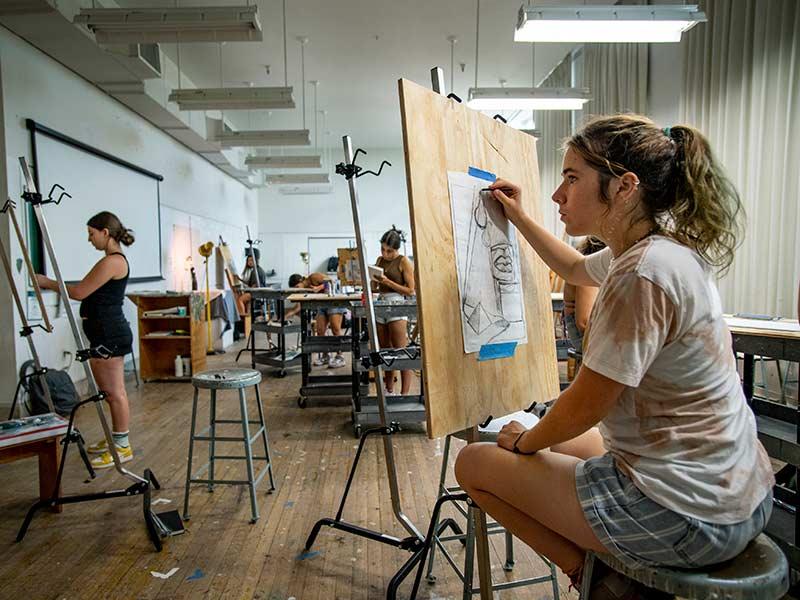 Tulane sophomore Madelyn Seward, right, focuses on the light and curves of a still life during professor Abdi Farah’s Foundations of Art: Painting class on Thursday, Sept 1, in the Woldenberg Art Center.