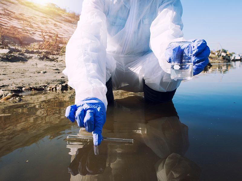 scientist collecting a water sample scientist collecting a water sample