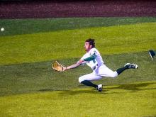 Outfielder Lex Kaplan goes for a sliding catch during Tulane’s home series against the University of San Diego Toreros over the weekend.