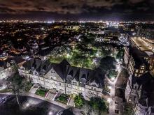 The Tulane uptown campus and the surrounding neighborhood glows at night in this drone photo. 