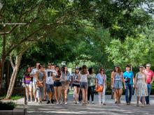 Visitors learn about life at Tulane during a walking tour across campus. 