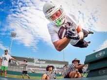 Reed Green, a sophomore wide receiver from Meridian, Mississippi, launches over bags during a drill on the first day of practice for the 2016 Green Wave football team held in Yulman Stadium on Friday (Aug. 5). 