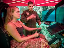 A member of the Tulane Naval ROTC program gets some virtual air time on a flight simulator set up on campus. 