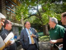Staff members beat the heat while enjoying a conversation with Tulane President Mike Fitts. 