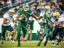 Tulane running back Josh Rounds runs for the Green Wave’s first touchdown of the game against Navy on Saturday (Sept. 17).