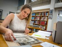 Kathryn Clinard examines a box of photographs in the reading room at the Amistad Research Center in Tilton Hall. 