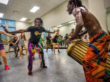 Members of a traditional Congolese dance and drum troupe, Vivien Bassouamina, center, and Teber Milandou-Sita far right, teach a dance class at McWilliams Hall on Monday (Oct. 17).