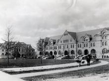 An unidentified man poses near oak saplings planted in front of Gibson Hall and Tilton Memorial Hall in the early 1900s. 