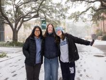 Students smile in the snow 