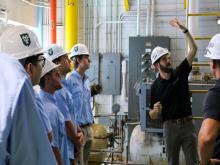 Jake Alter, vice president of engineering at ENFRA, explains how the gas powerplant on Tulane’s uptown campus functions during an MME tour in August 2025. Photo courtesy of Chad Chenier. 