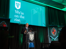 President Michael A. Fitts at podium during 2025 State of the University address