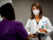 Dr. Michele Longo consults with a patient Dr. Michele Longo consults with a patient