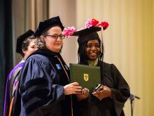 School of Professional Advancement Dean Suri Duitch, left, presents a graduate with a diploma during the 2018 SoPA Undergraduate Graduation Ceremony. (Photo by Frank L. Aymami III)