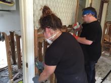Cowen Institute staff members work on a flooded home. Cowen Institute staff members work on a flooded home.