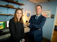Laura Perry and Michael Hoerger standing in office