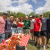 President Michael A. Fitts with students behind a table with crawfish
