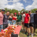 President Michael A. Fitts with students behind a table with crawfish