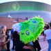A grad with a decorated umbrella outside the Superdome