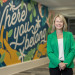 Dean Amelia Manning in front of a mural